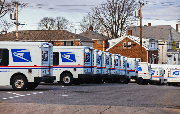 Image of USPS trucks lined up. | GrayCyan